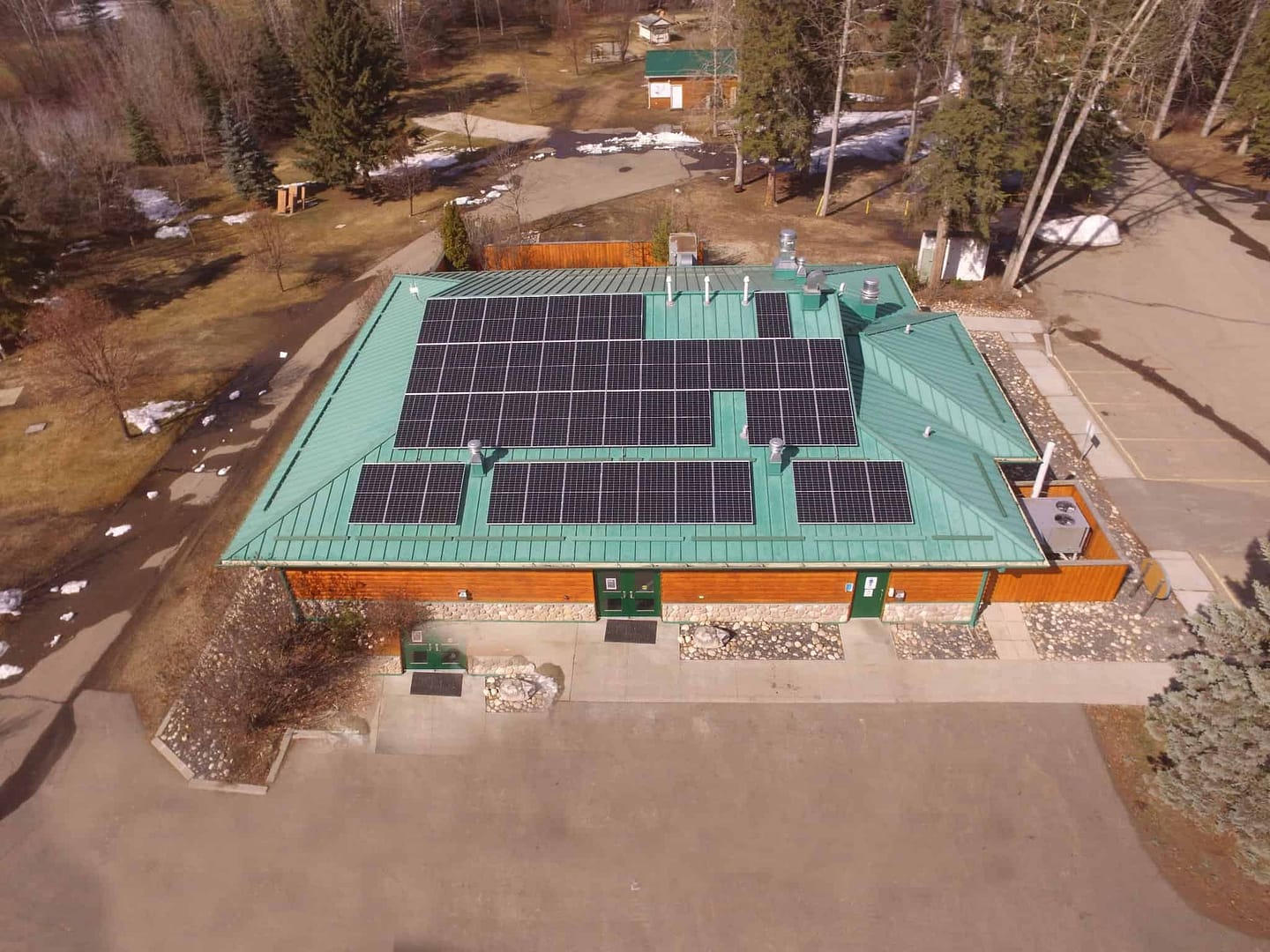An aerial view of Devon Lions Campground with solar panels on the roof, harnessing the power of the summer sun to contribute to the efficient operation of the Solar Grid.