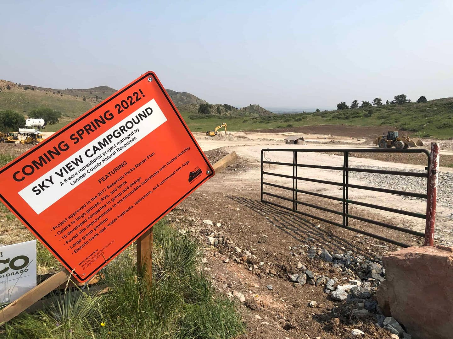 A sign is posted in front of a Larimer County construction site.