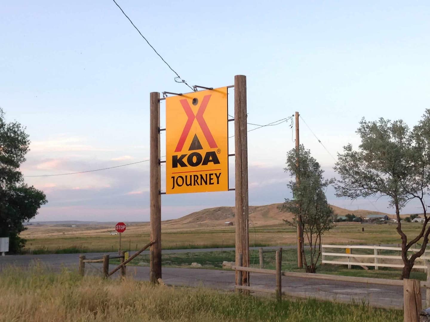 Douglas KOA's sign marks the ownership of a ranch in the middle of a field.