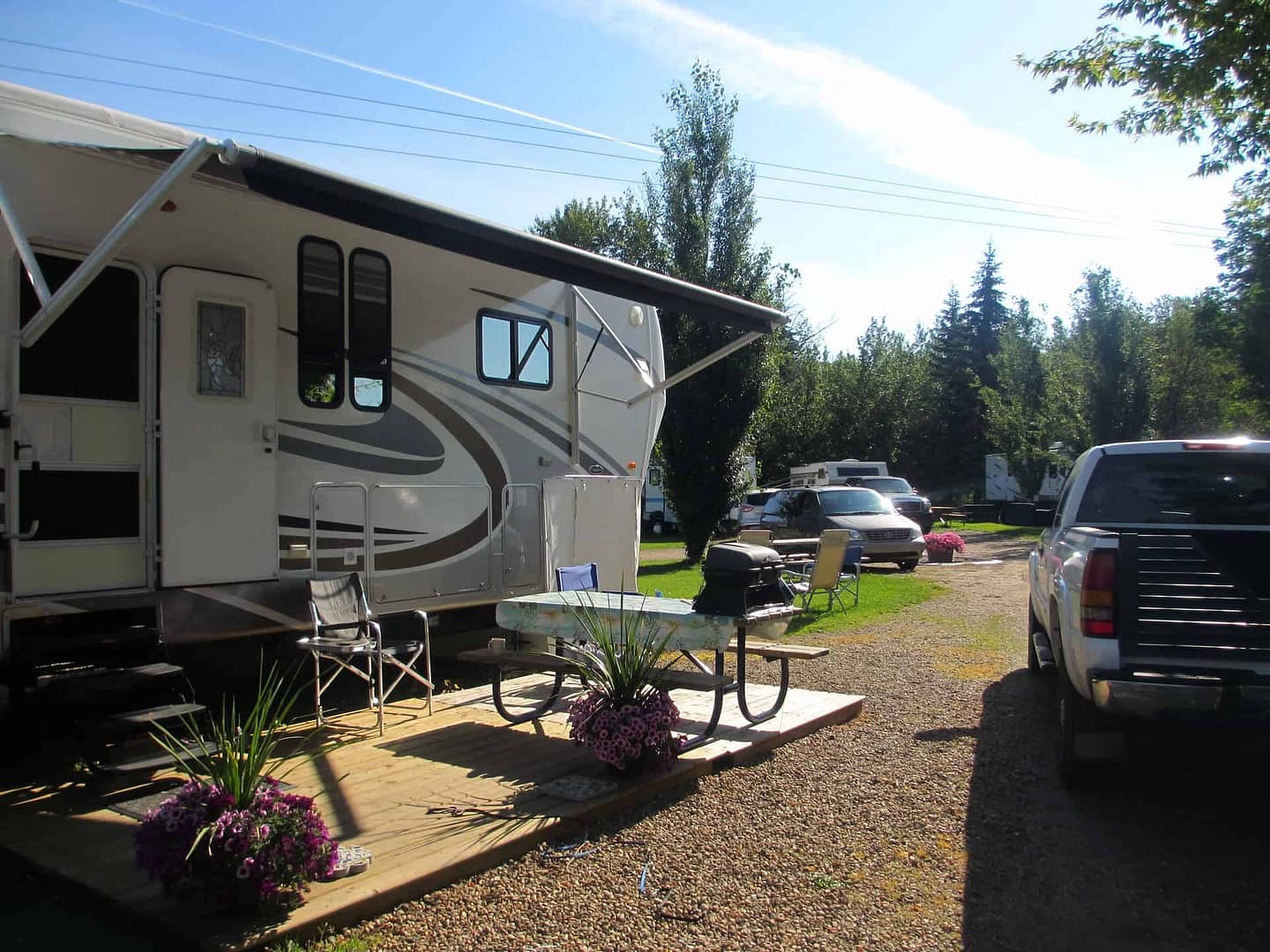 A Grand Opening rv parked in a gravel lot at Turner Park Campground.