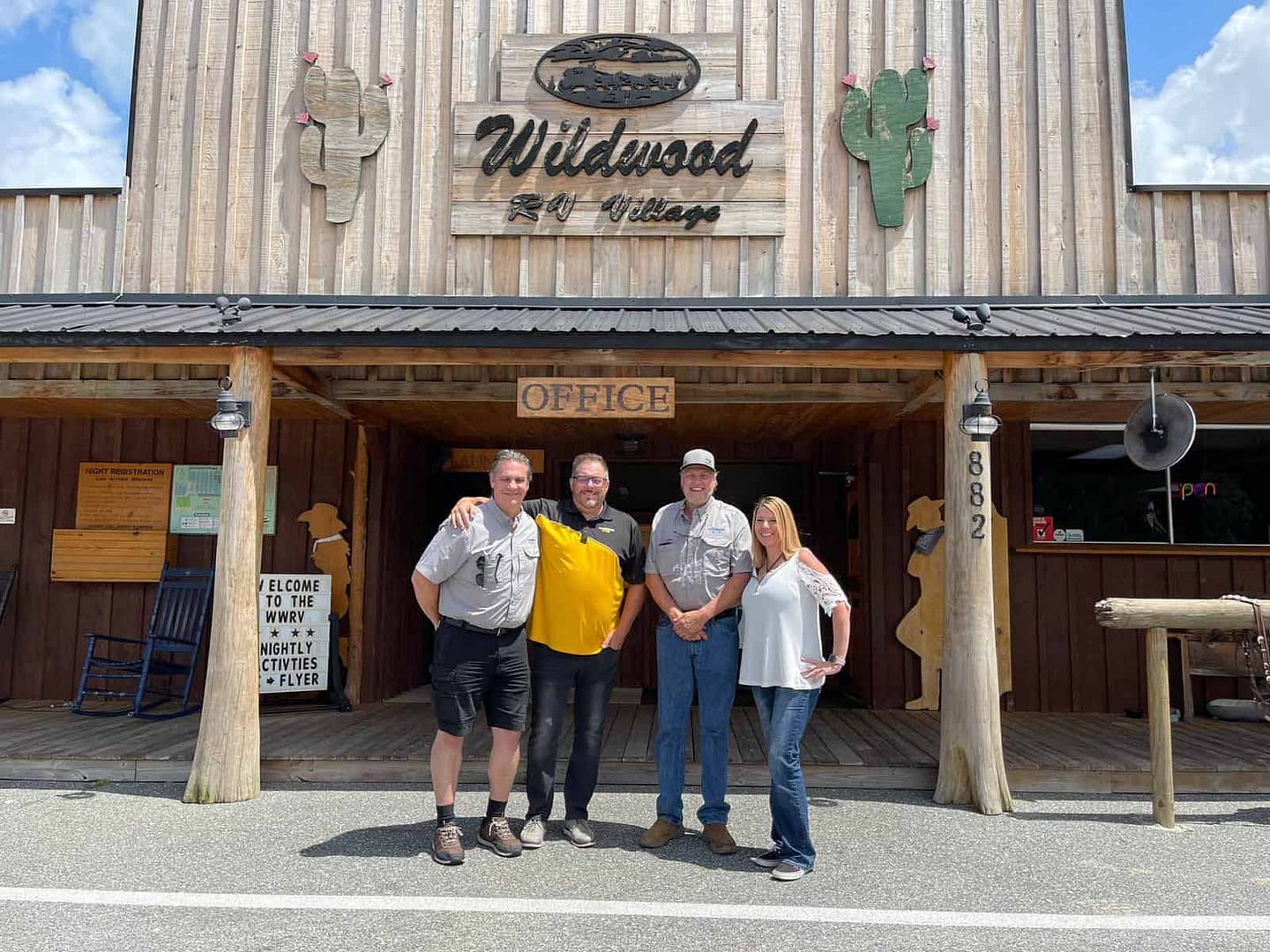 Three people standing in front of a Florida building.