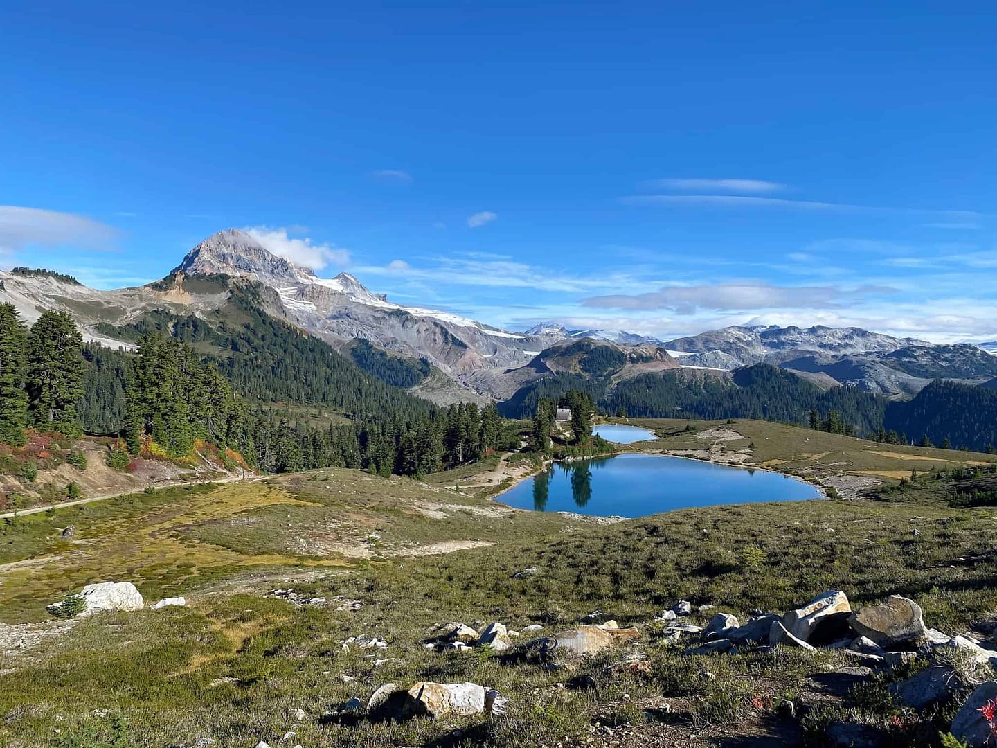 A record-breaking camping season at BC Parks with a stunning lake nestled in the mountains as a breathtaking backdrop.