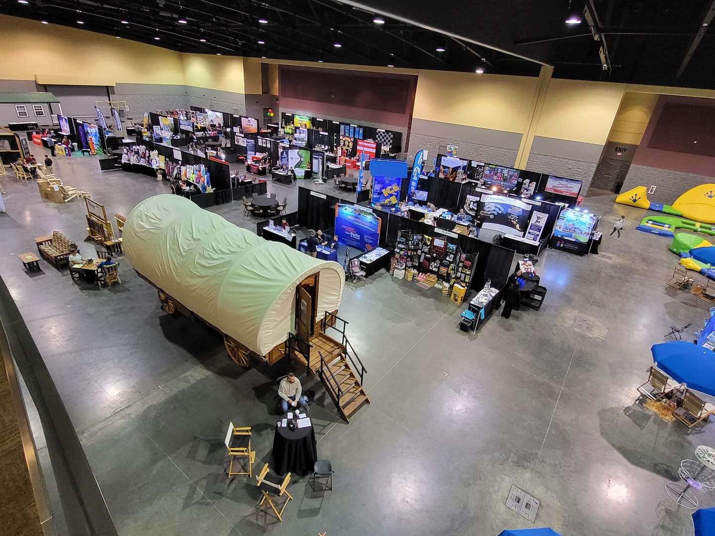 An aerial view of an expo convention hall with a covered wagon.