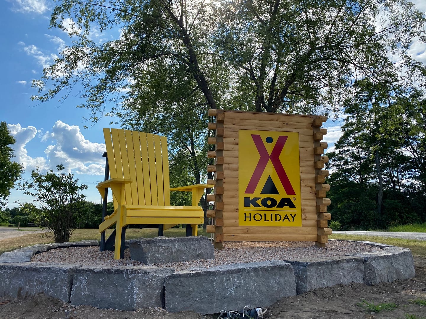 A yellow adirondack chair sits in front of a Northumberland Businesses sign.