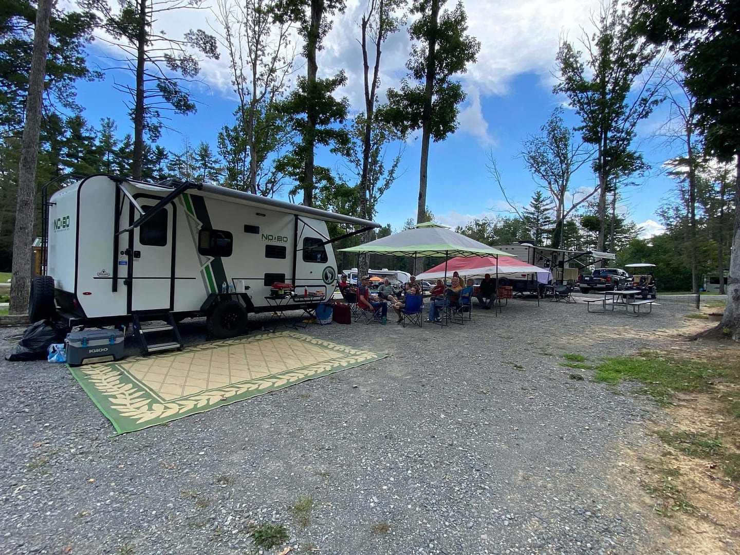 A group of rv's parked in a wooded area, perfectly located for the 2024 Total Solar Eclipse at Spacious Skies Campgrounds.