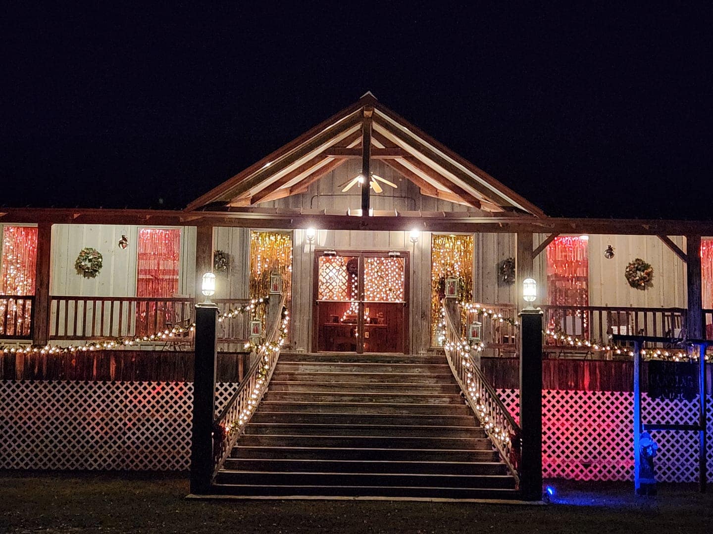 The Scotts Ferry General Store, located at the Christmas Drive-Through campground, displays a beautifully lit house at night with festive Christmas lights.