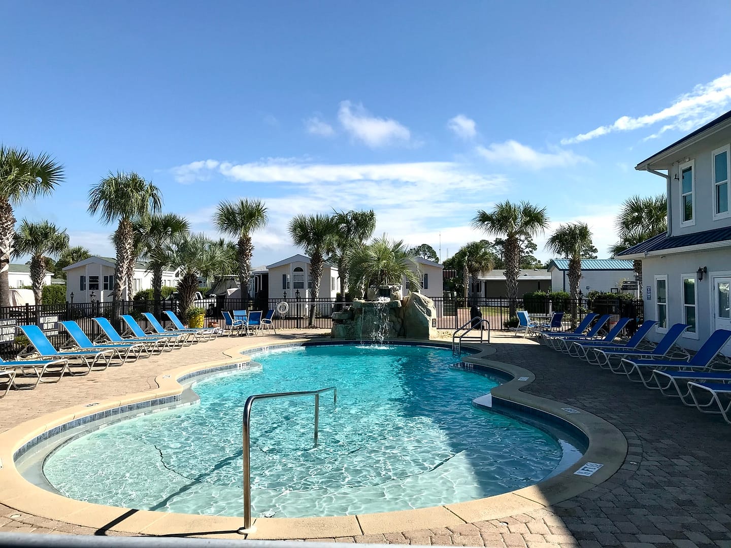 A pool surrounded by palm trees in Winter Haven, perfect for Snowbirds in the Florida Panhandle.