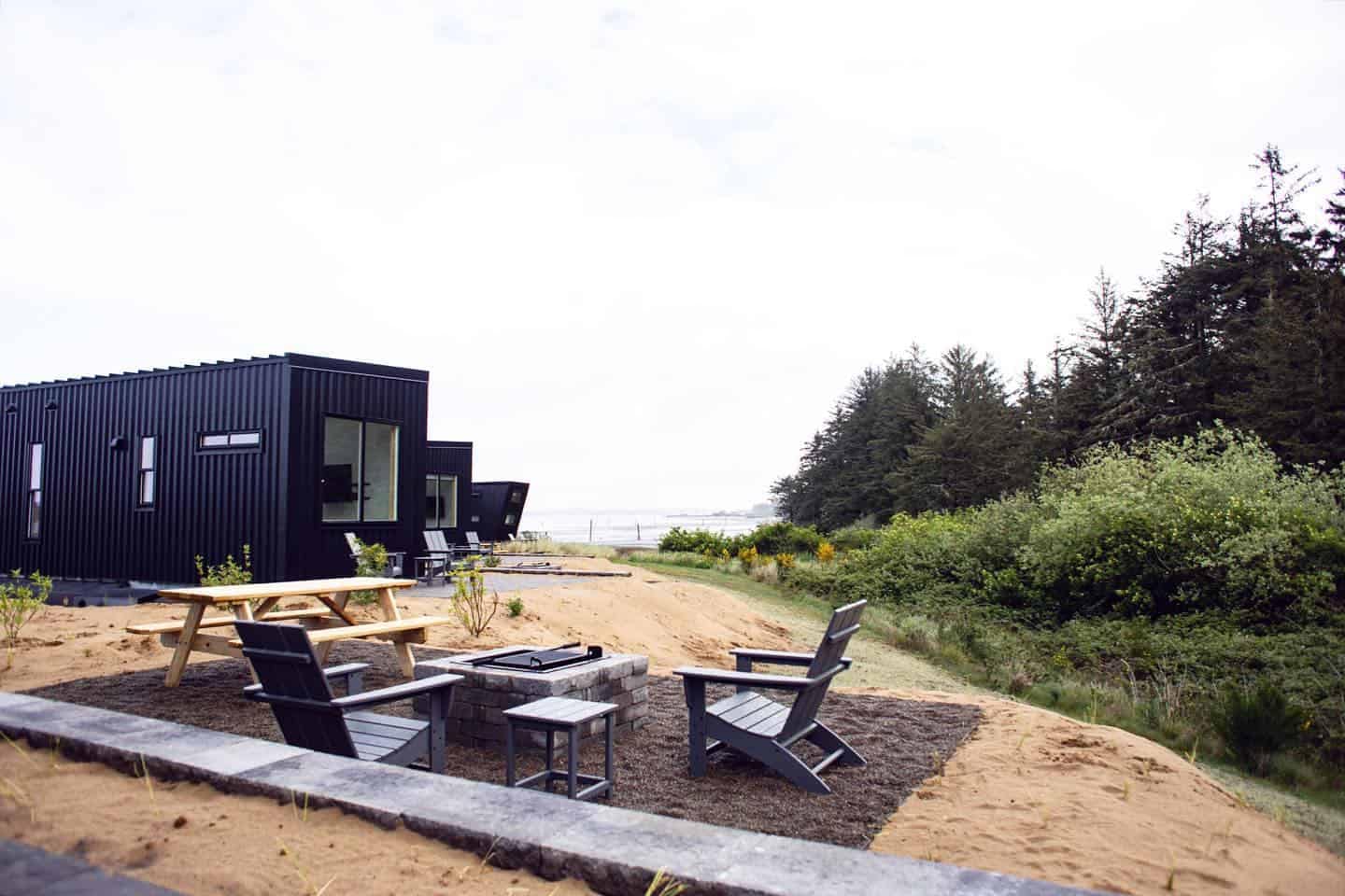 Bay Point Landing's modern cabin offering sits in the sand next to a fire pit.