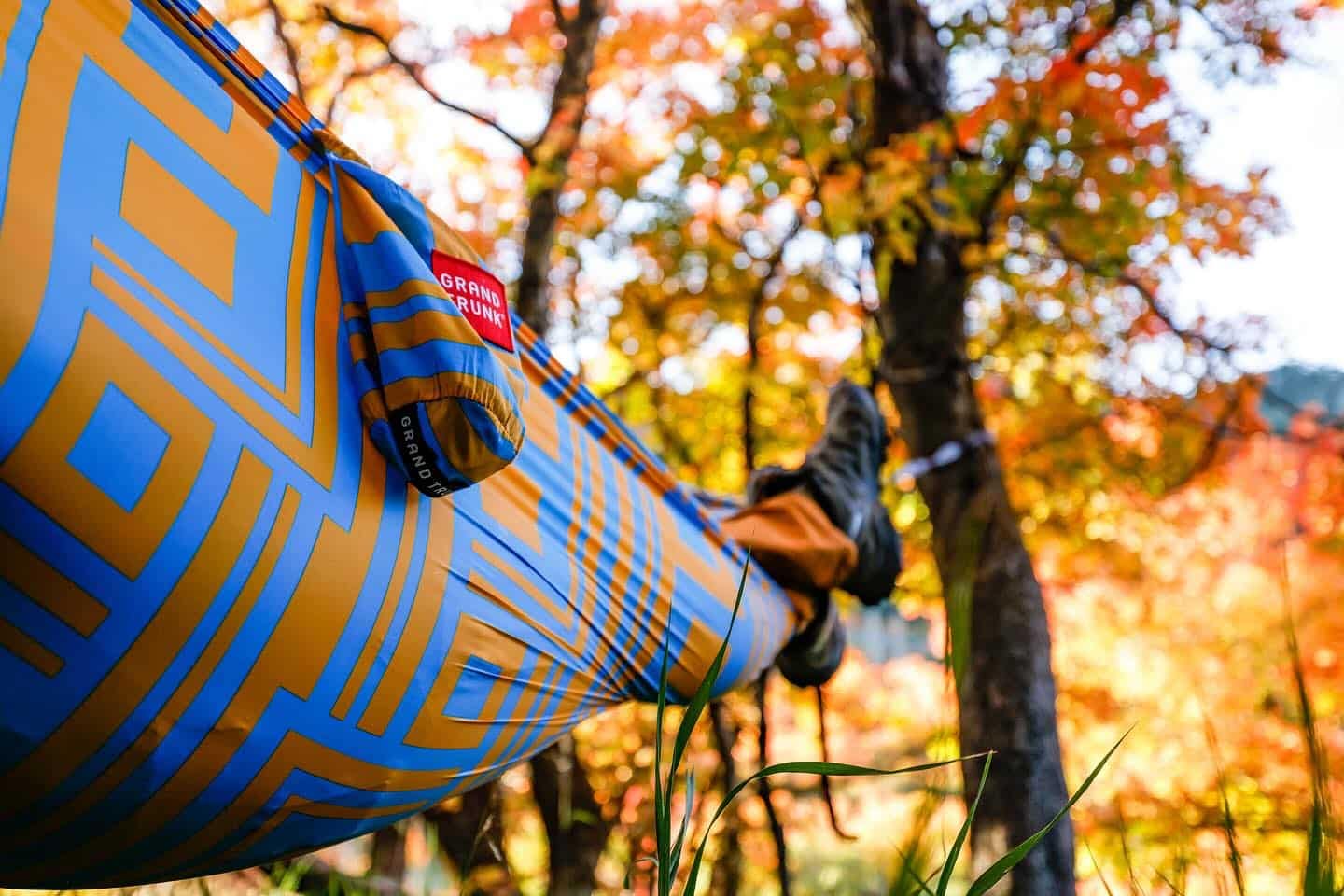 A person enjoying the comfort of a Grand Trunk hammock.