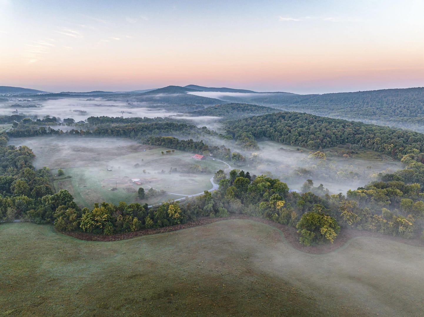 An aerial view of Loudoun County, Virginia's newest state park situated in a foggy valley.
