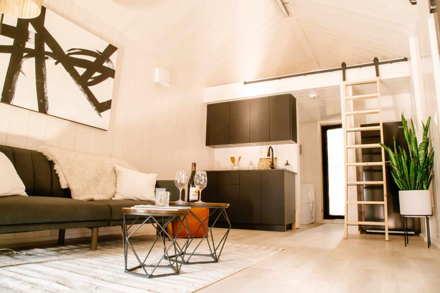 The living room of a tiny house with a ladder, perfect for those interested in joining the RV Technical Institute Recruitment Drive.