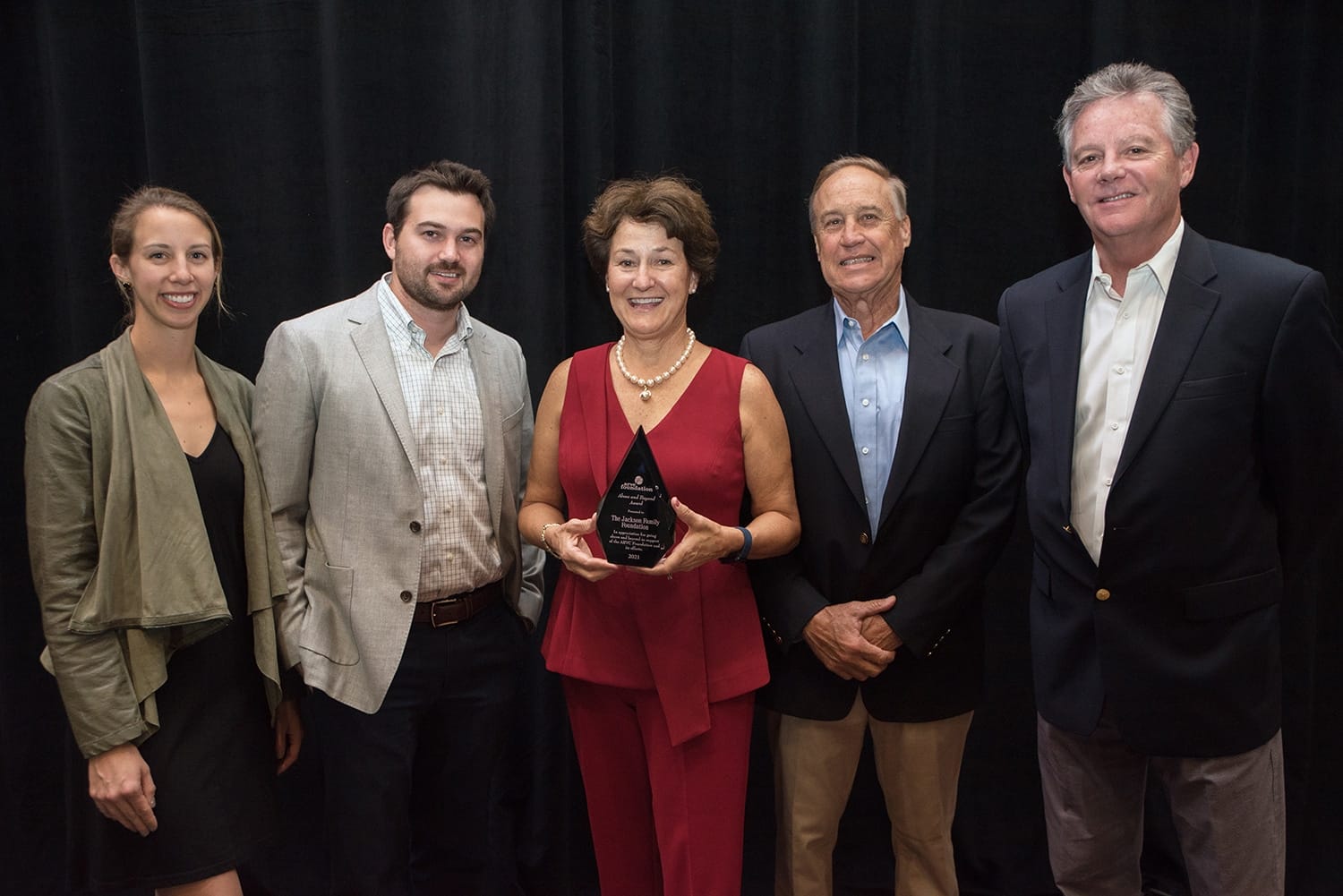 A group of people posing for a picture with an ARVC Foundation award.