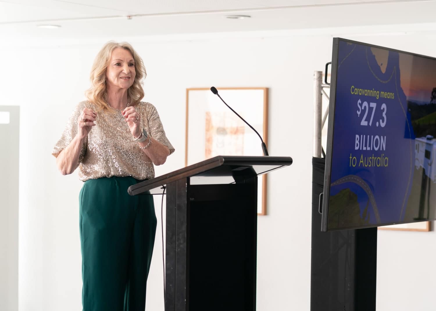 Woman delivering Auto Draft presentation with statistical information on screen.