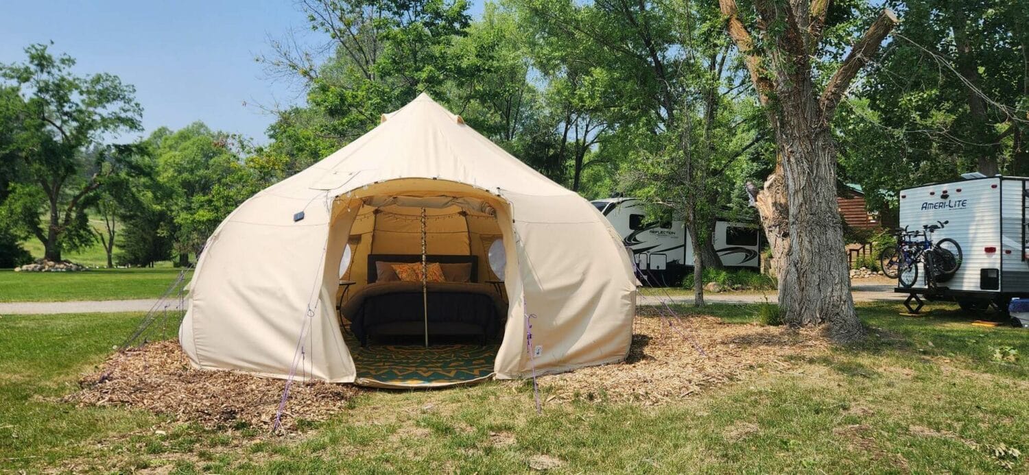The Silverline Lakeside Resort, under new owners, is revitalizing its offerings with a tent set up on the grass next to an RV.