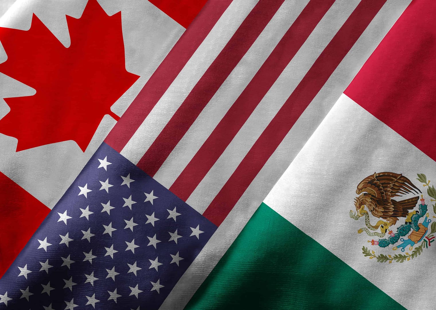 This is a display of Canadian, Mexican, and American flags representing the trilateral trade agreement known as USMCA. The agreement aims to promote automotive goods trading among these nations.