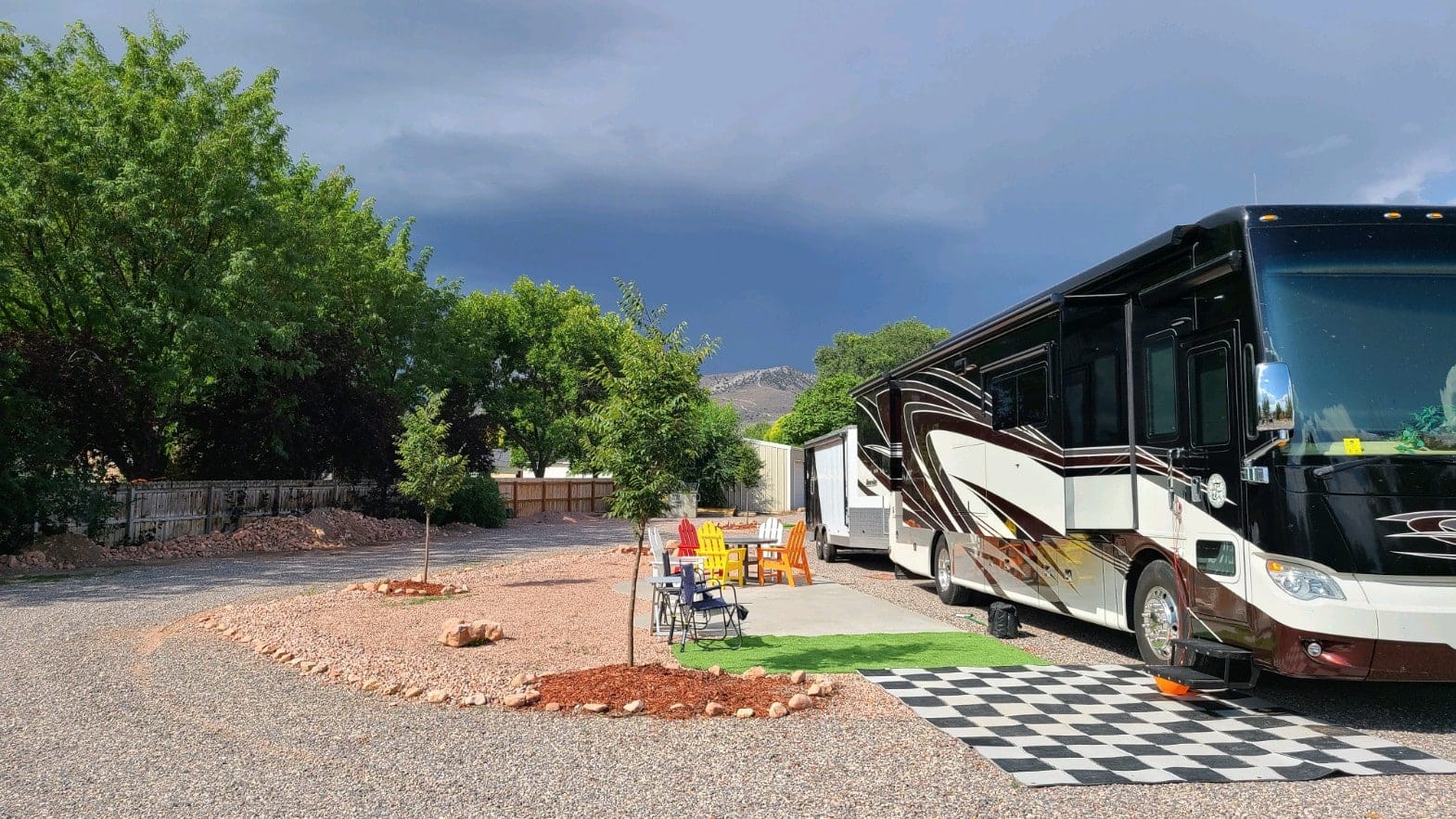 A large RV parked in a gravel parking lot near the Richfield KOA.
