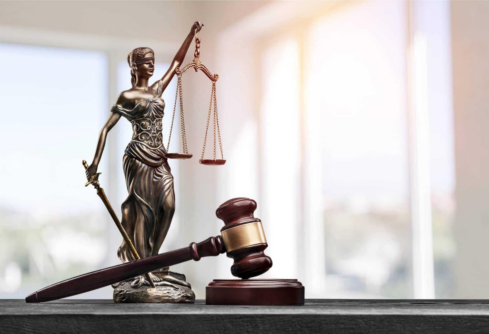 A statue of justice on a table, symbolizing the Appeals Court's role in overseeing lawsuits in NC County.