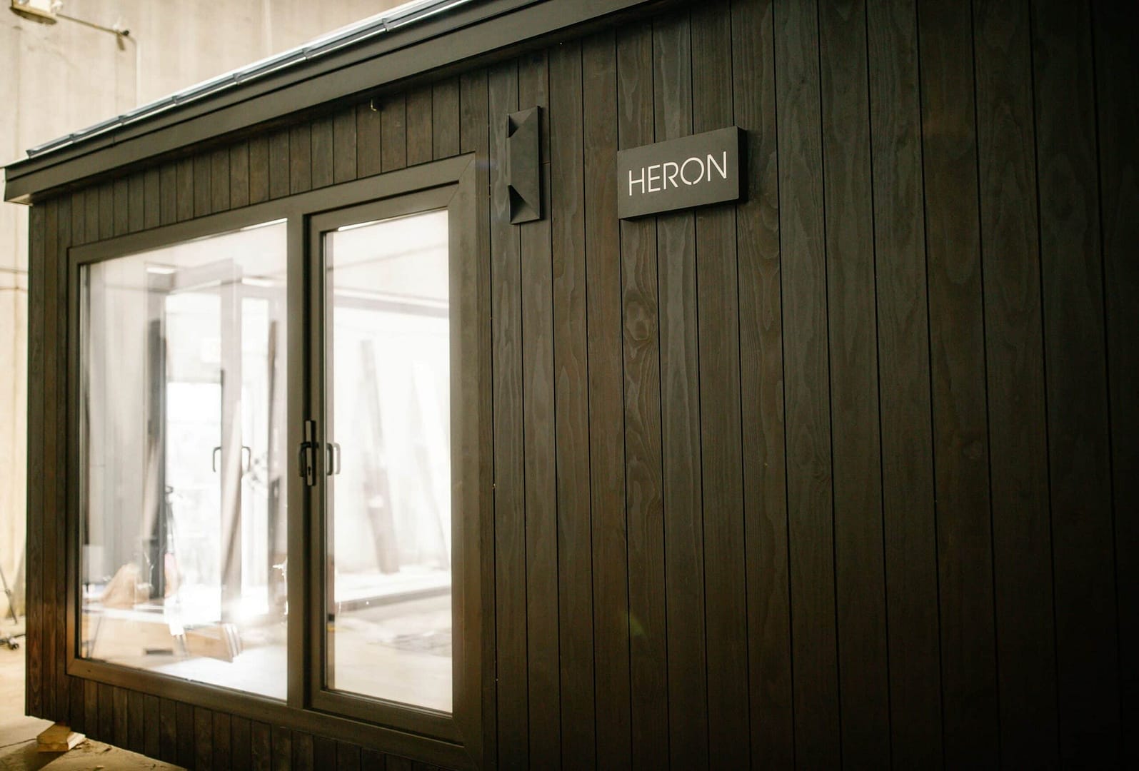 A small wooden building with a door on it, perfect for those in search of luxurious tiny homes.