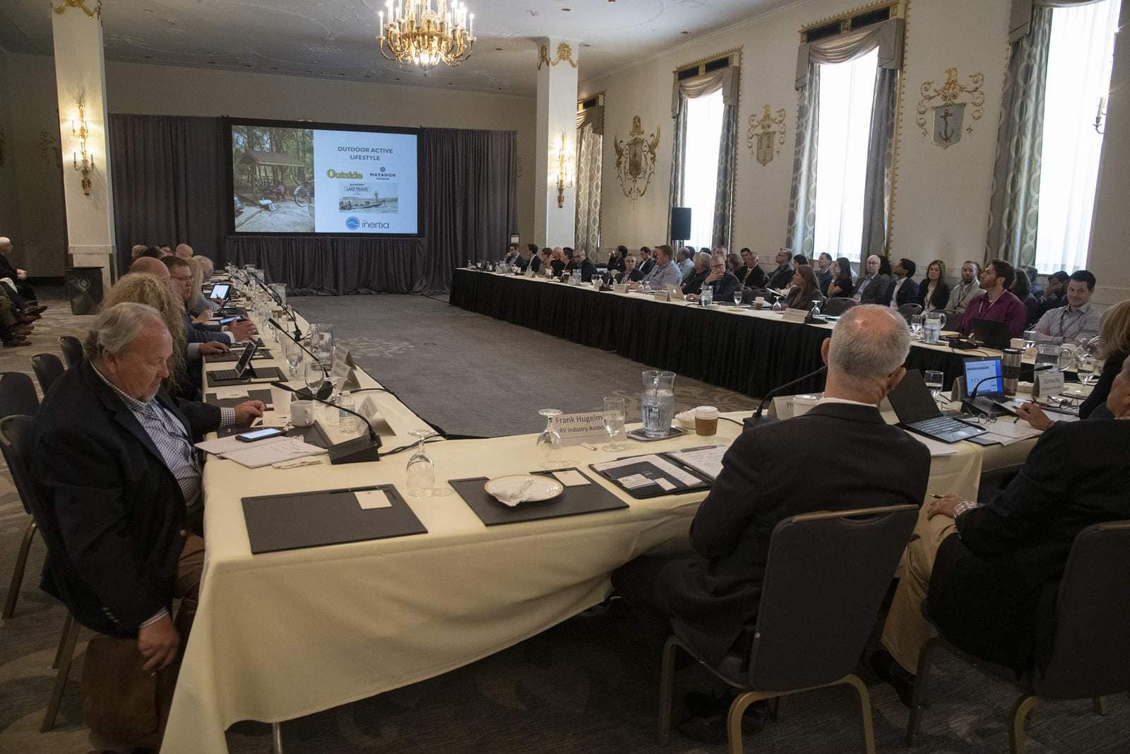 A group of people sitting around a table in a conference room discussing RVIA registration for RVs.