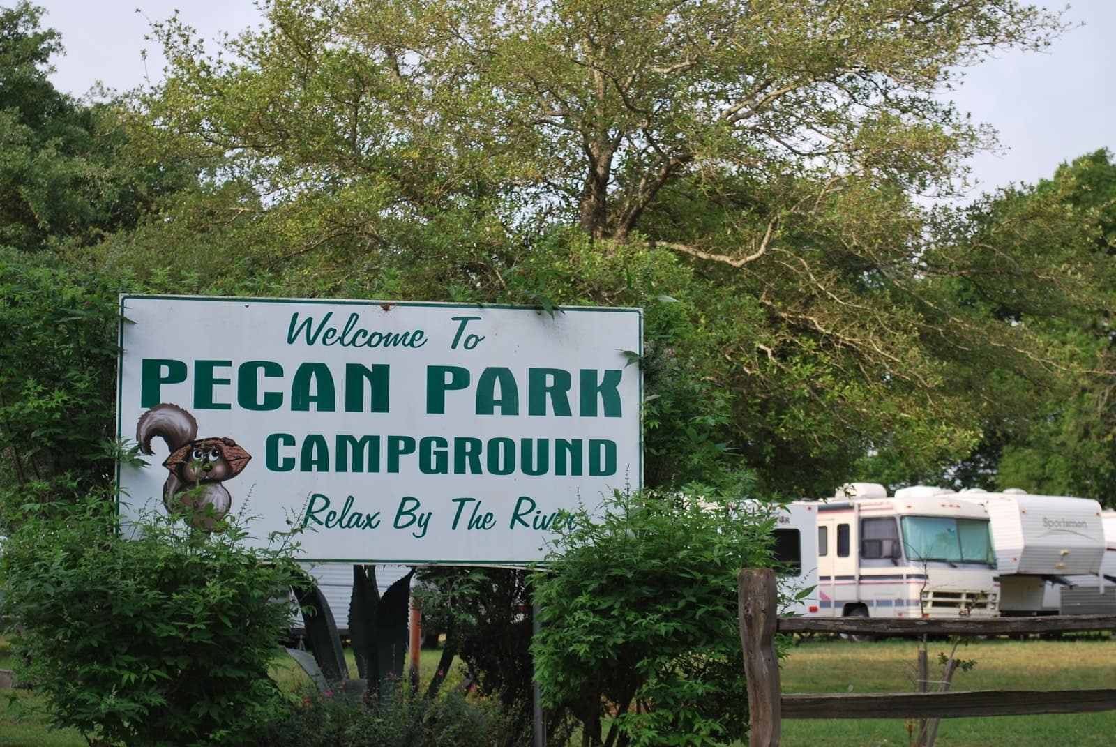 A picturesque sign showcasing Pecan Park Campground among the vibrant colors of the Fall season.