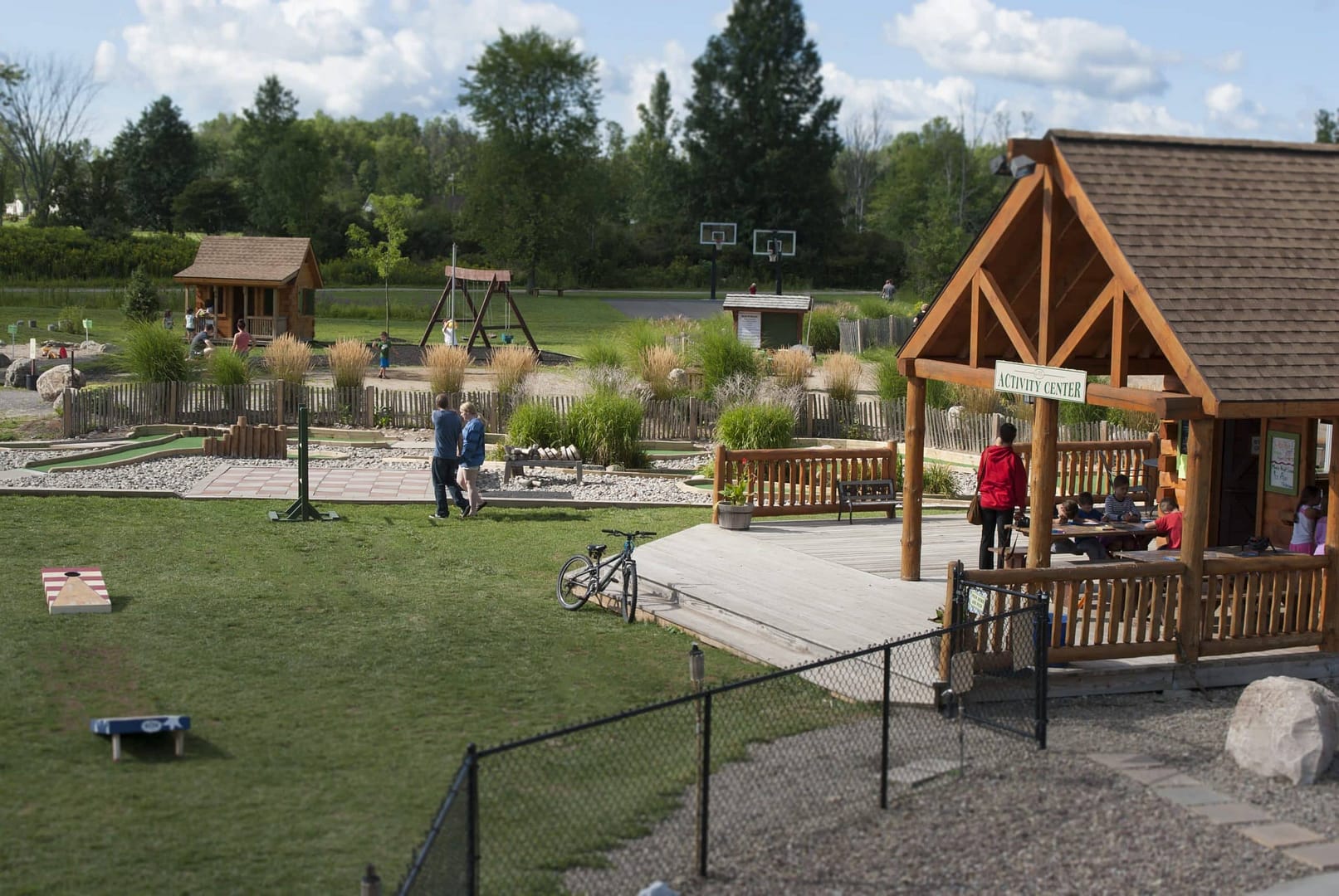 A group of people are playing a game of mini golf in Branches of Niagara, Upstate NY's Premier Campground.