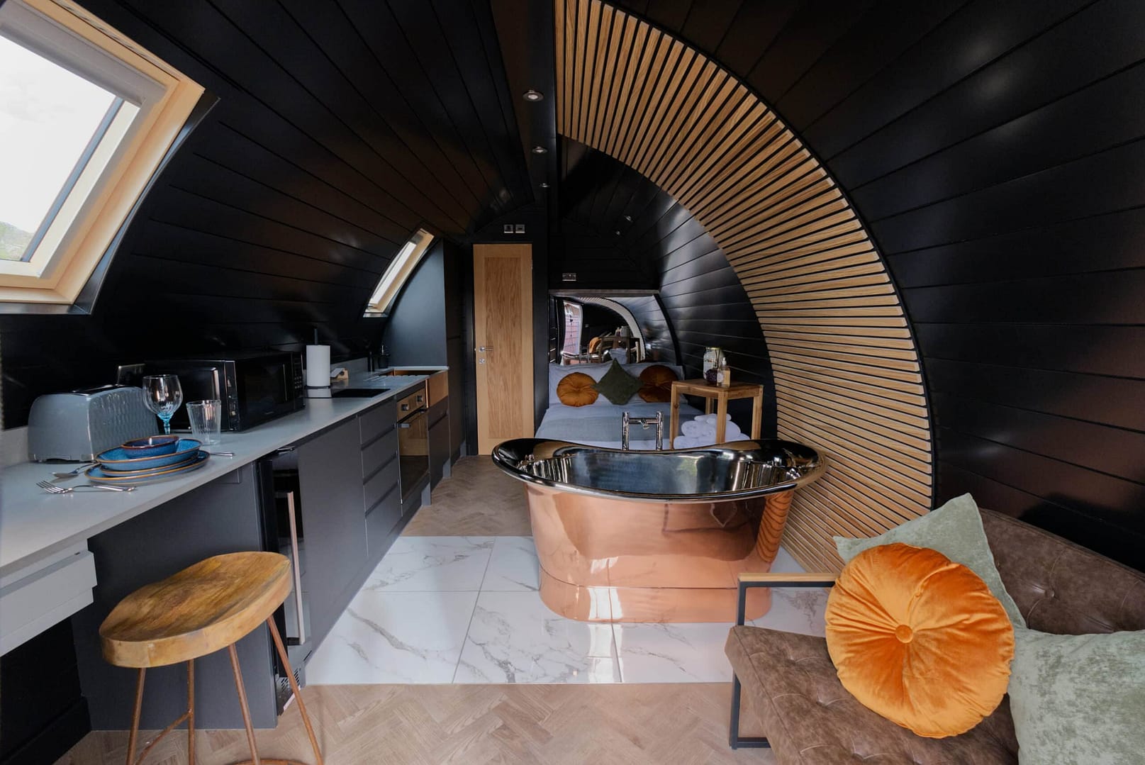A black and white bathroom with a bathtub in an Innovative Accommodation Concept.