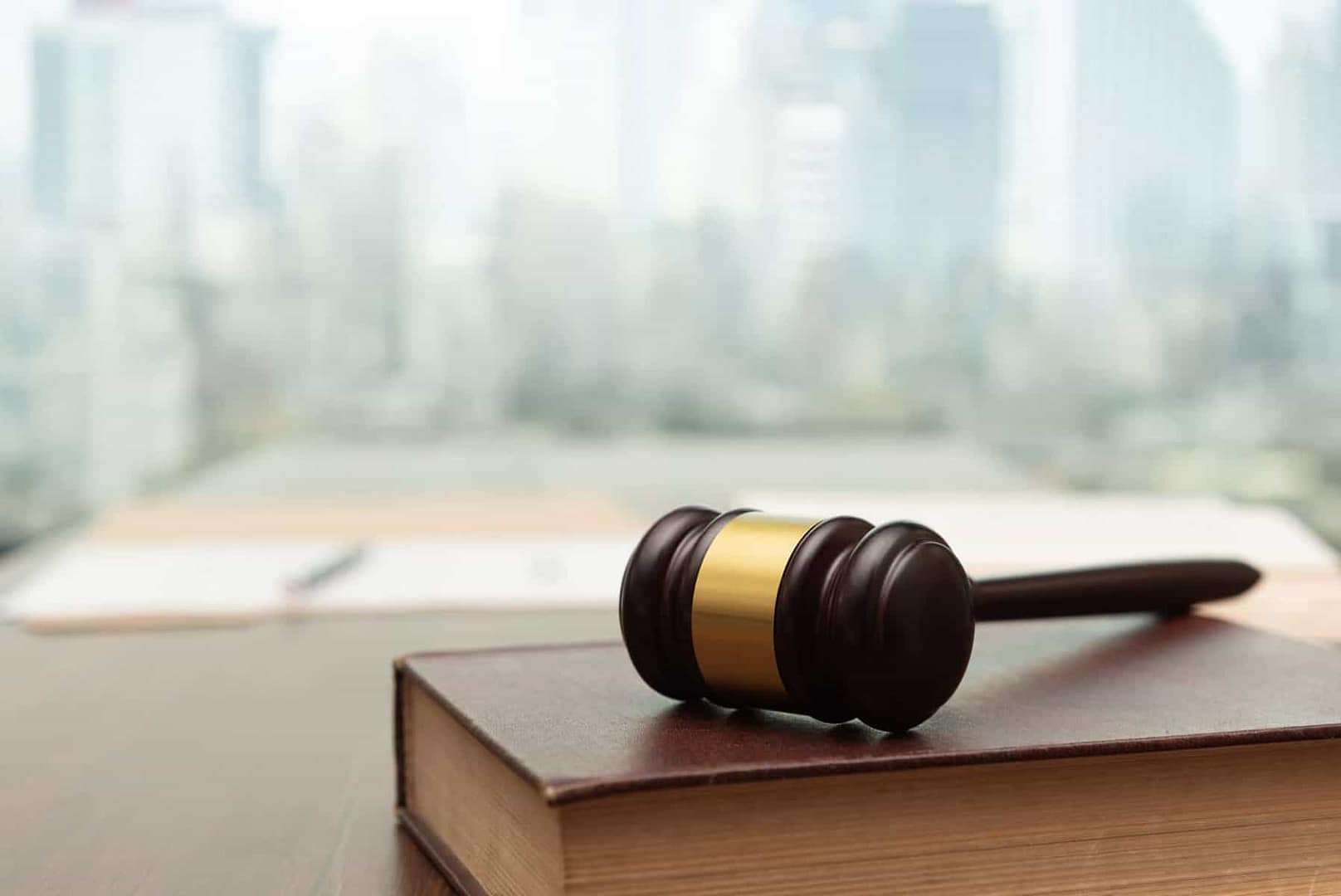 A judge's gavel rests on top of a book, symbolizing the power and authority wielded by the judiciary in Michigan's legal system.