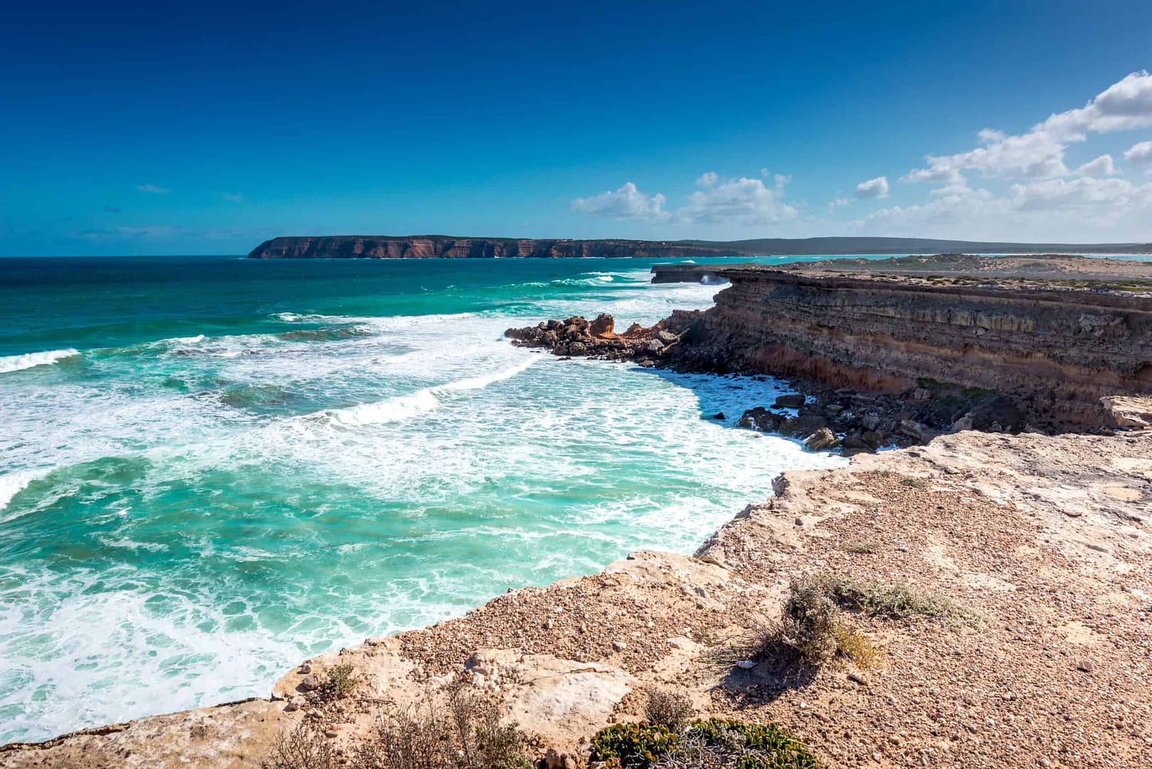 A cliff overlooking the ocean and Eyre Peninsula Beaches, with a rocky coastline.