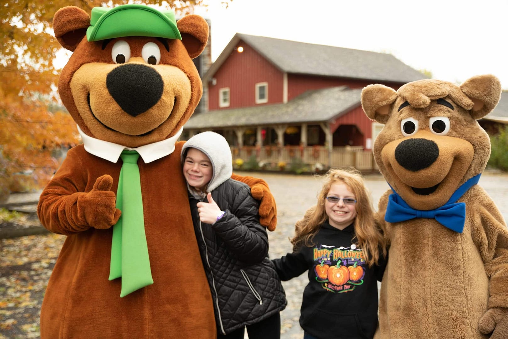 Three children participate in activities with a teddy bear mascot.