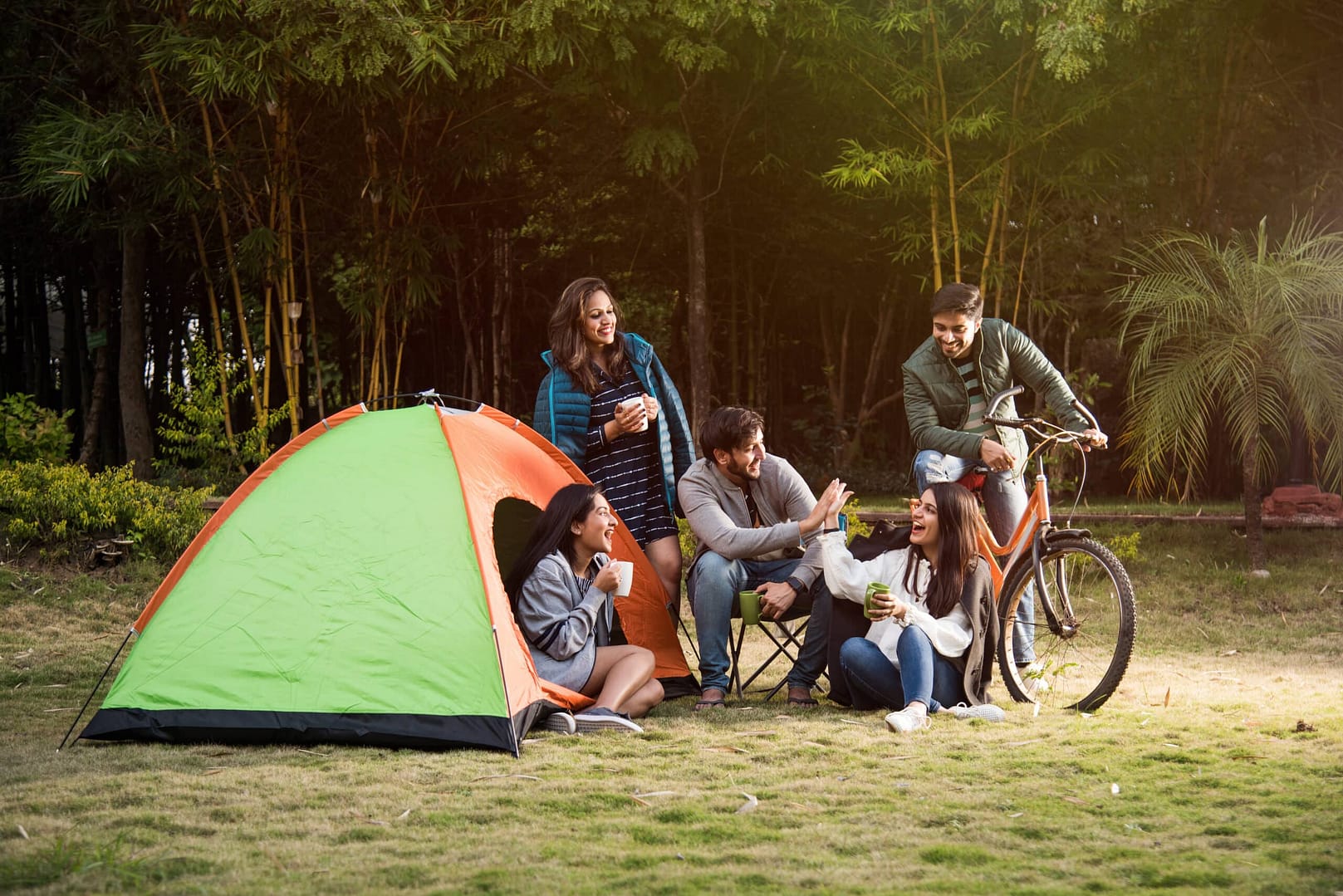 A group of people camping around a tent in Delhi.