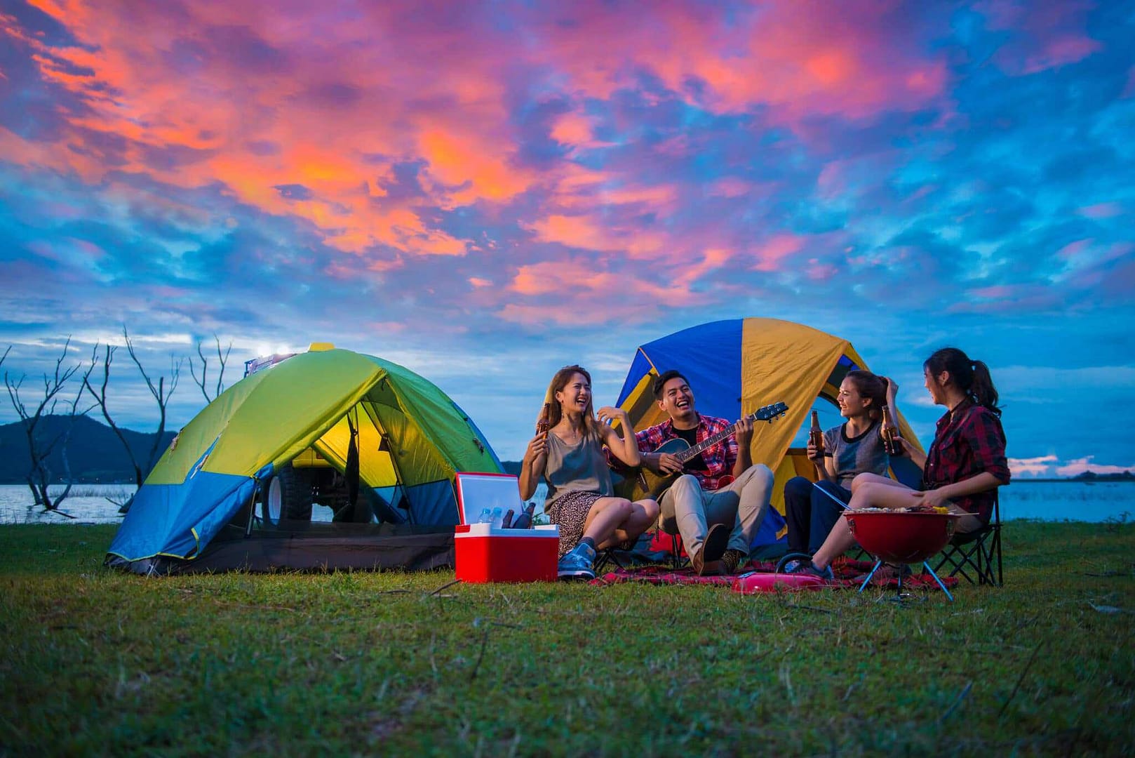 Campers sitting around a tent at sunset in Colorado Camping.