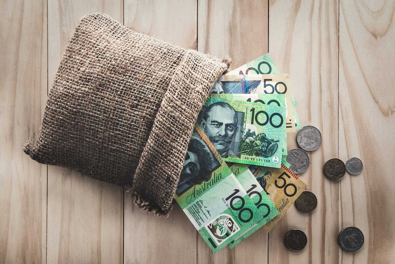 Australian currency in a sack on a wooden table in the Upper Hunter.