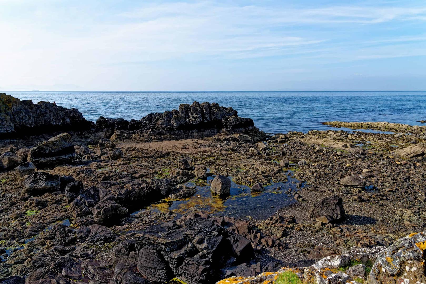 Parkdean Resorts invests in a rocky shore with a blue sky and a lot of rocks for their Caravan Holiday Park.