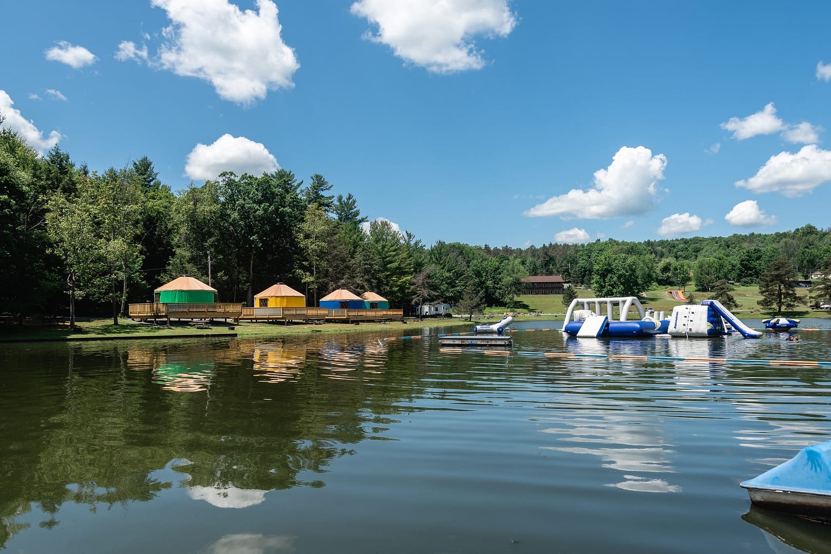 Binghamton Jellystone Park offers a Haunted Campground Experience with water slides and tents in the background, perfect for an adventurous visit with Yogi Bear.