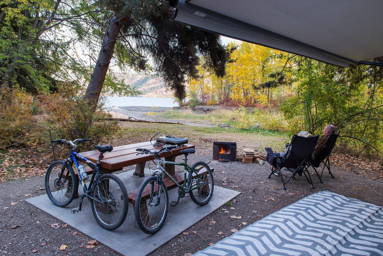 A couple of bicycles parked next to a campfire at Bear Creek Park.