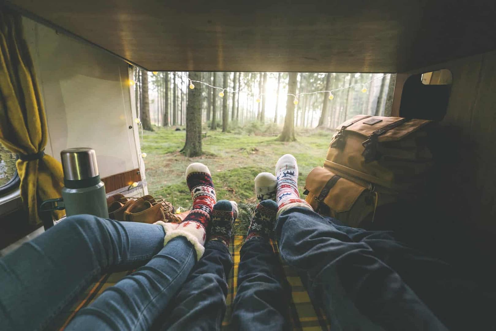 Workers' feet in the back of a camper in the Colorado woods.