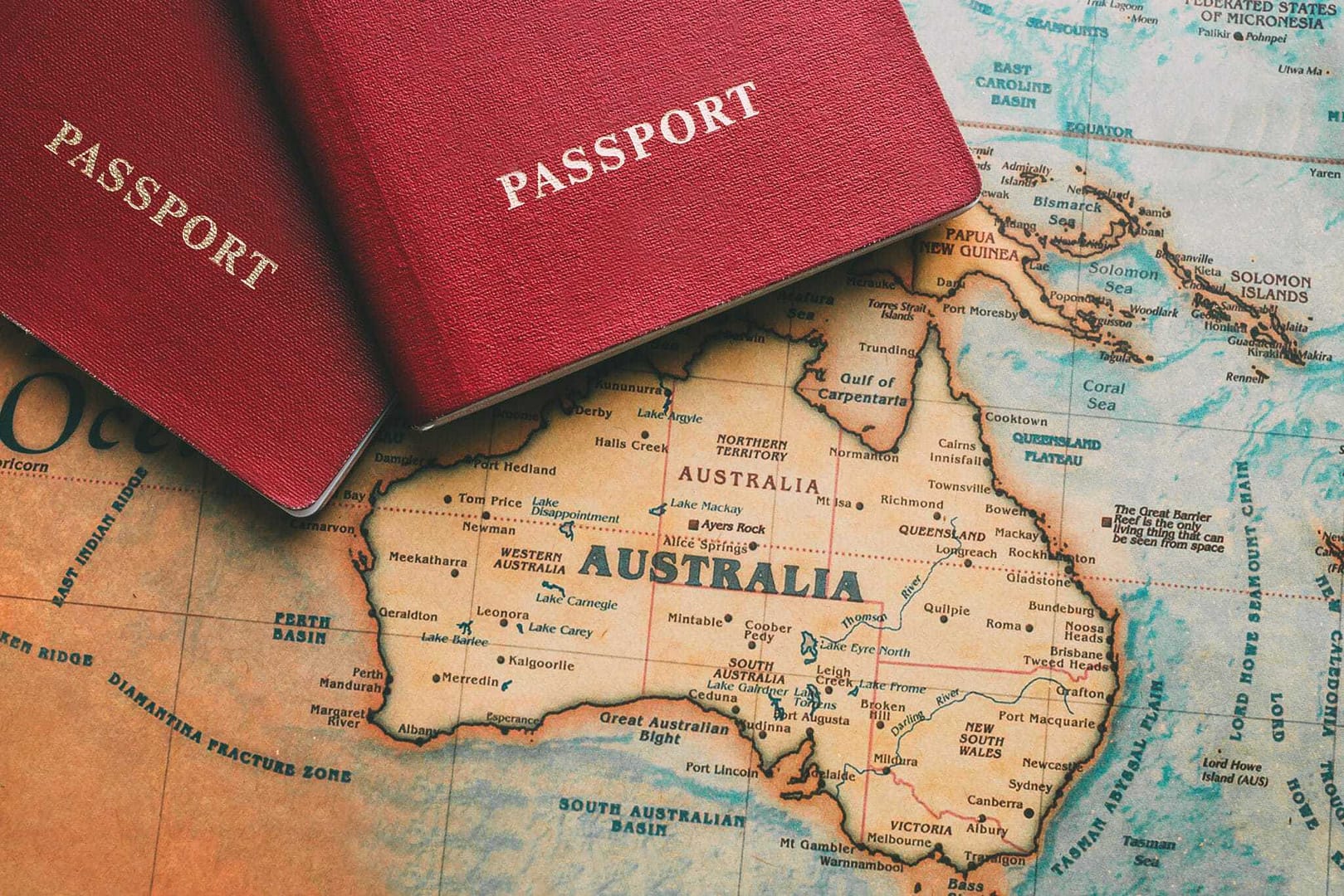 Two passports on top of a map of Australia, perfect for Outback Tourism and Travelers Guide enthusiasts exploring Queensland.
