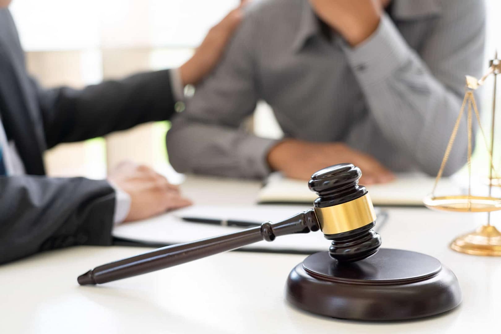 A judge grants a gavel to a businessman involved in legal actions.