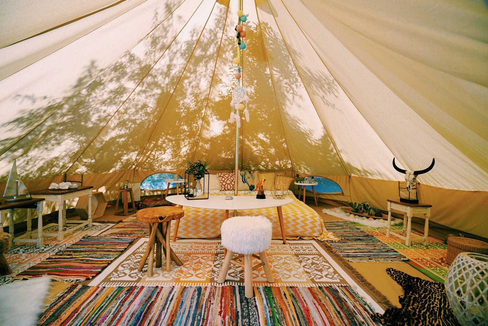 A room in a Utah glampground tent with a rug on the floor.