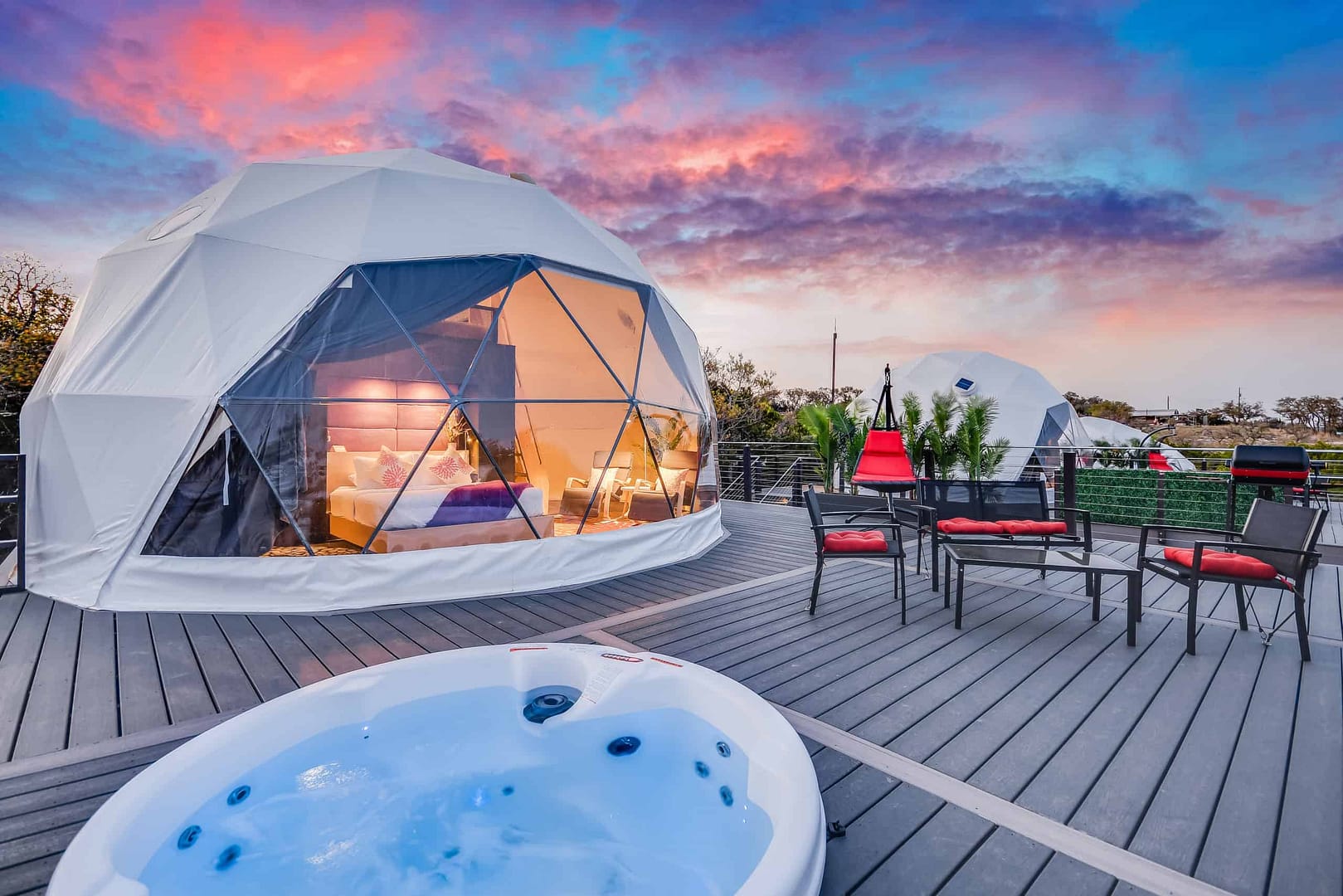 A romantic hot tub on a deck with a stunning view of the Texas sky.