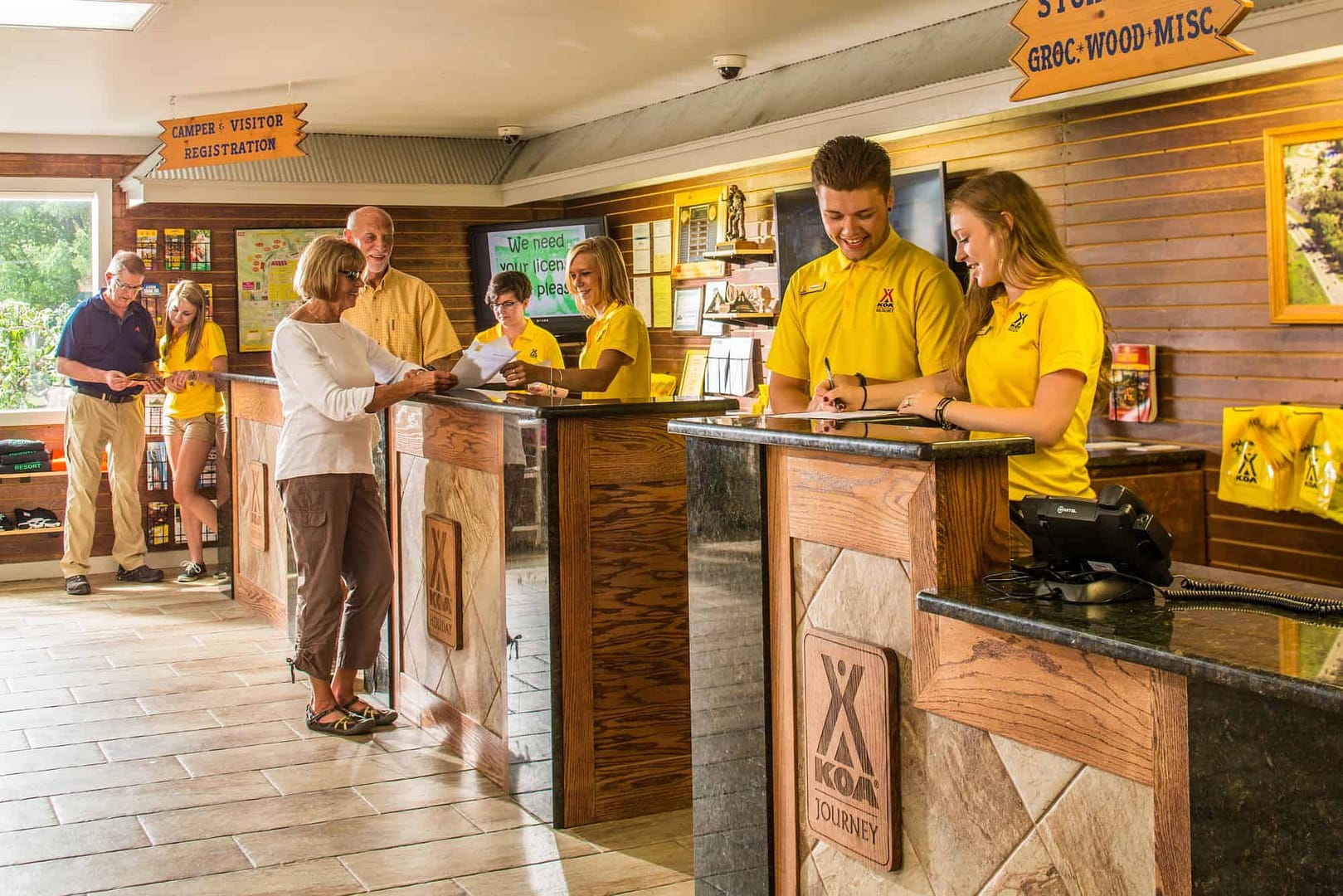 A group of franchisees standing in front of a counter.