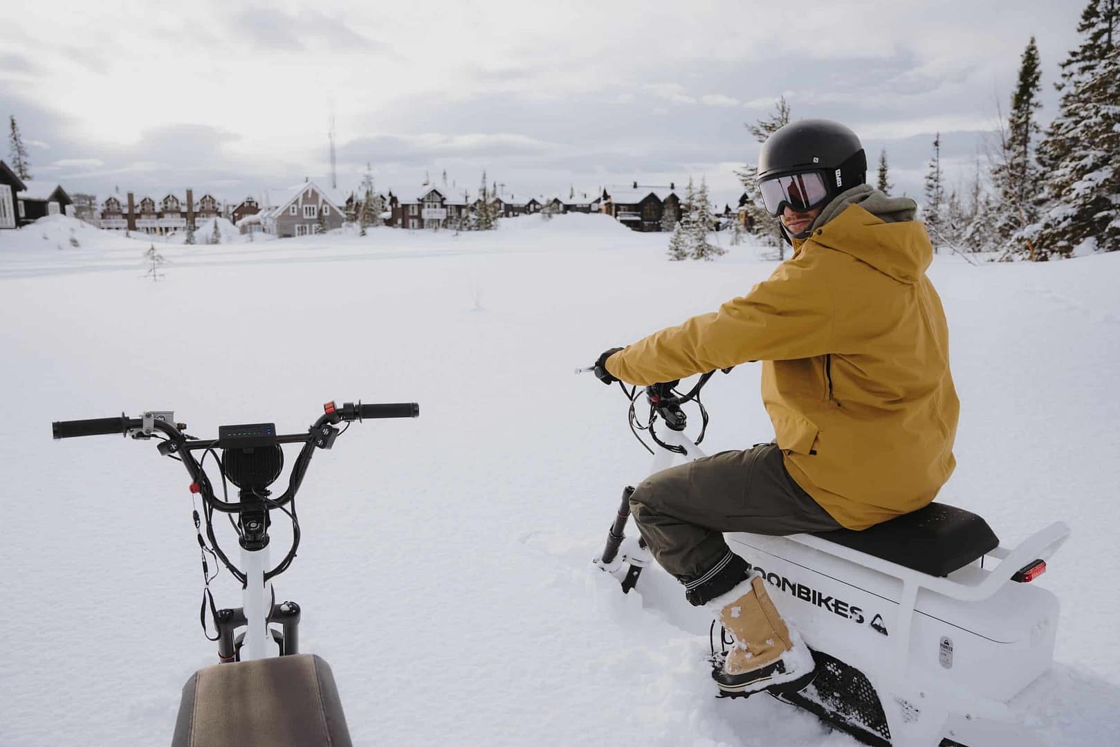 A man is riding an Electric Snowbike in the snow at The Resort at Paws Up, enjoying his Winter Adventure.