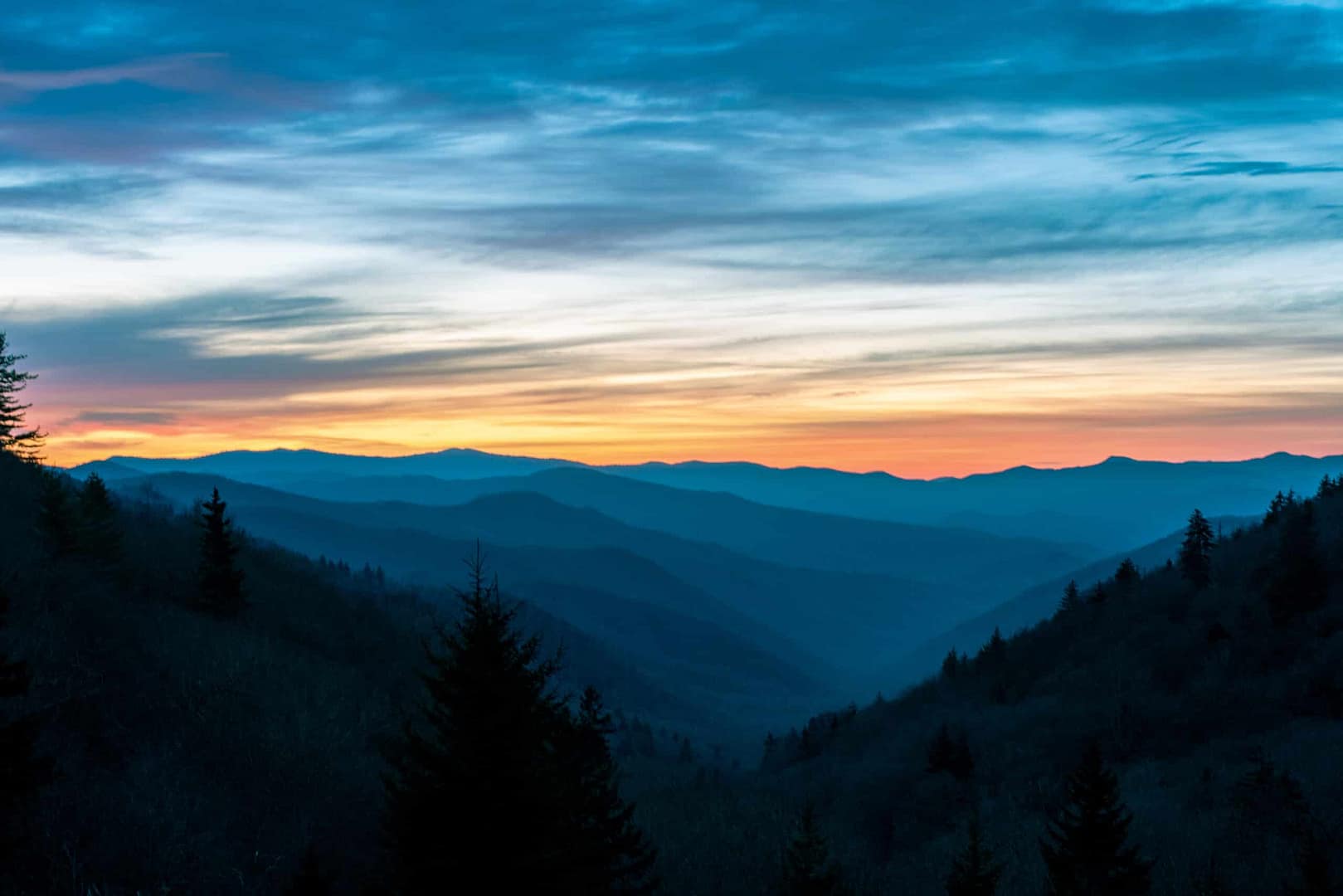 The great smoky mountains at sunset offer breathtaking views of nature's beauty, perfect for campgrounds and visiting visitor centers.