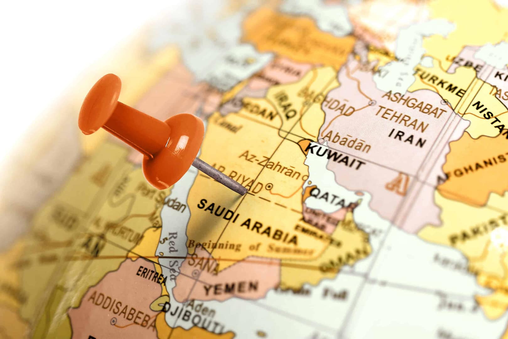 An orange pushpin marking a location on a world map, specifically on iran.