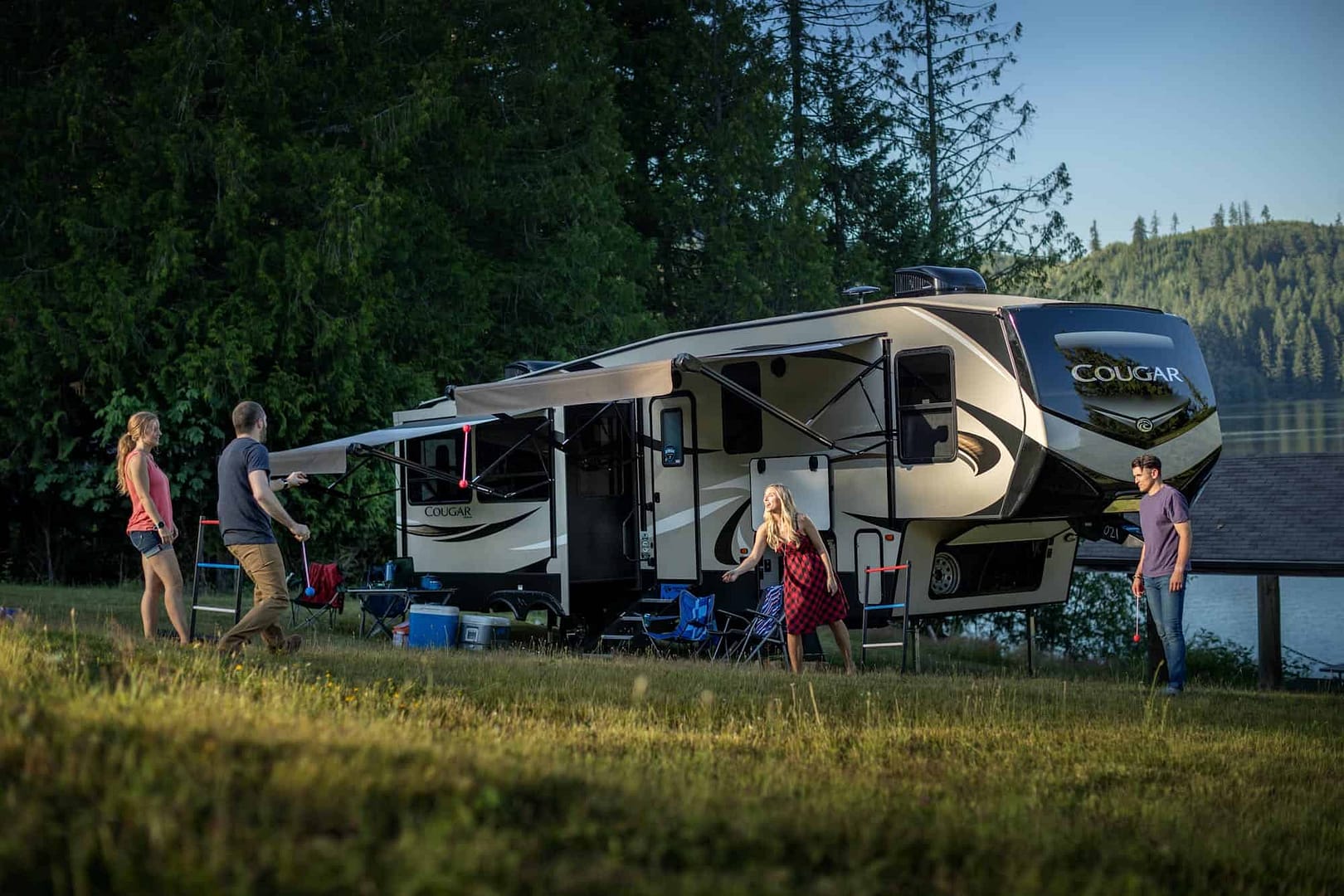 A group of people standing next to a Keystone RV.