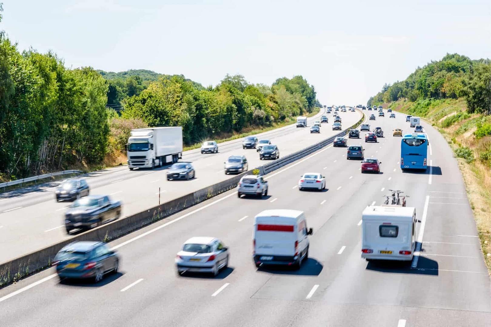 A group of cars driving down a highway on a sunny day in South Carolina.