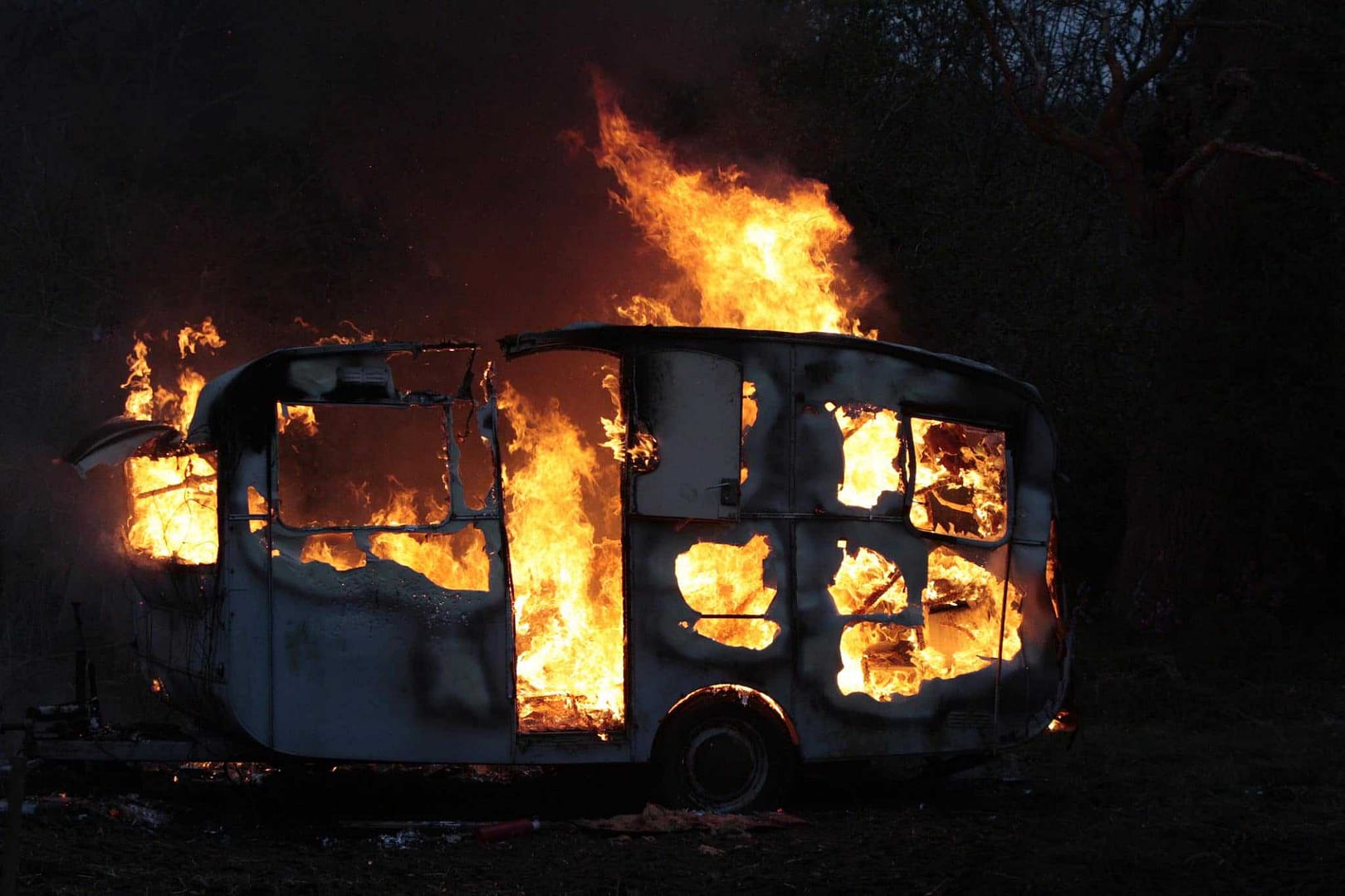 A **fire** has broken out in the woods, endangering a camper's **RV**. The immediate response of the **Fire Chief** is crucial to prevent further damage and ensure the