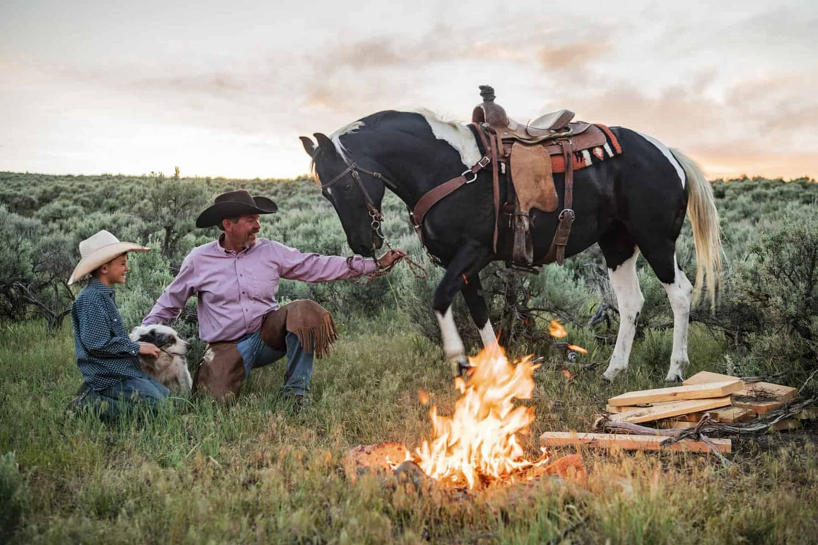 A man and woman sit around a campfire with a proposed equine campground in Wisconsin.