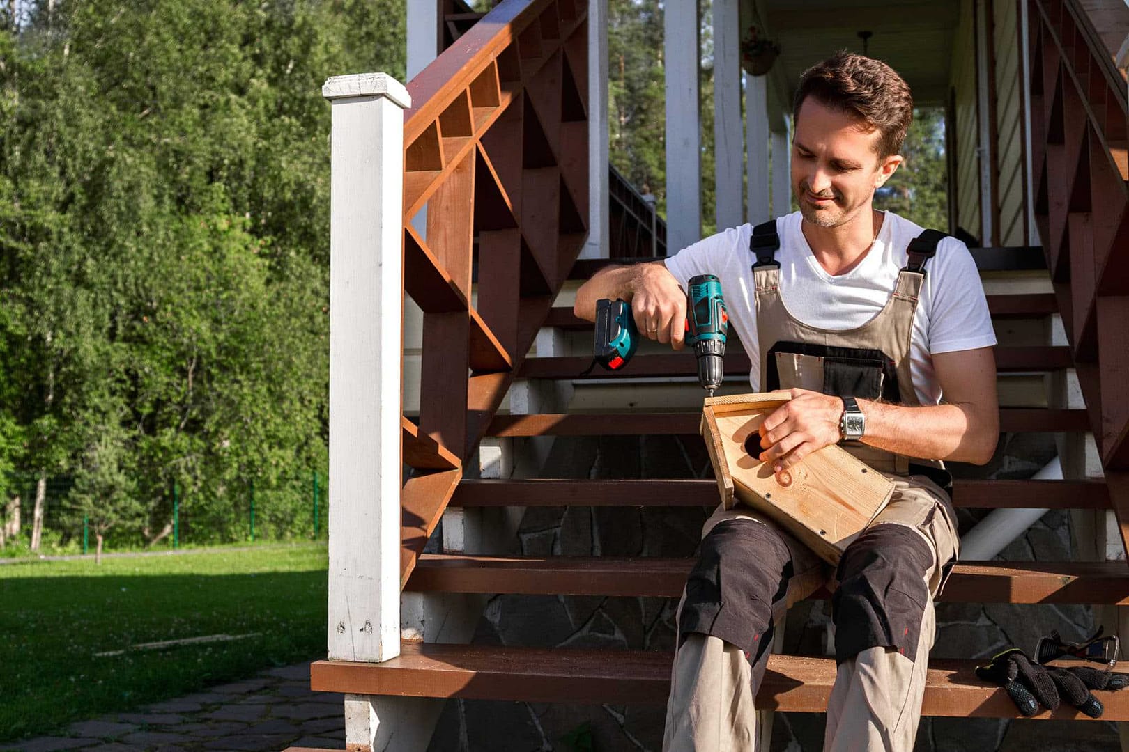A man is sitting on the steps of a Florida house.
