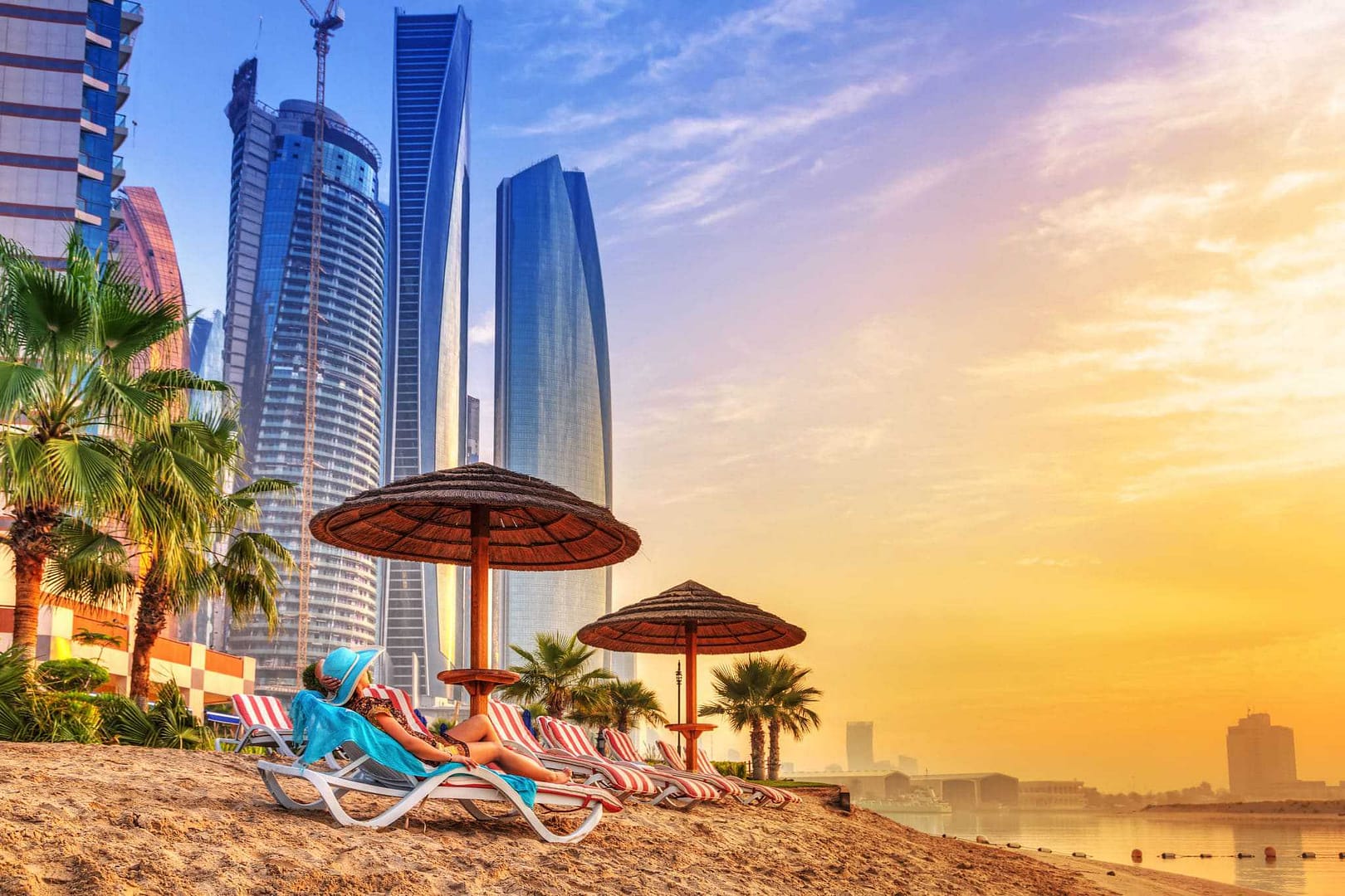 Glampers relax on the beach at sunset in Dubai.